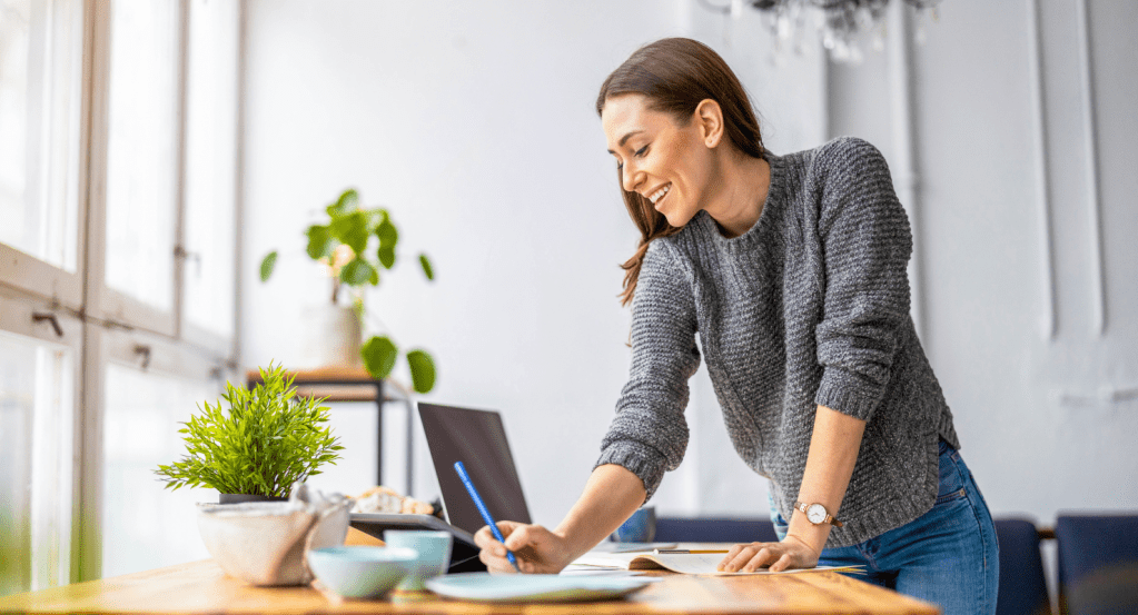 Office worker creating a shopping list for all their back-to-work essentials.