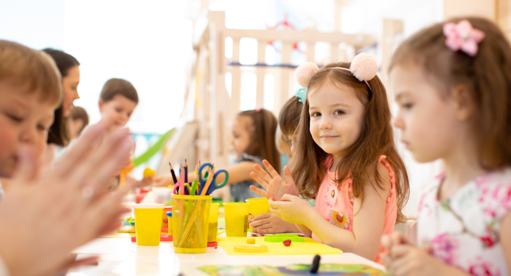 Children engaged in back-to-school arts and crafts activities in a bright, cheerful classroom.