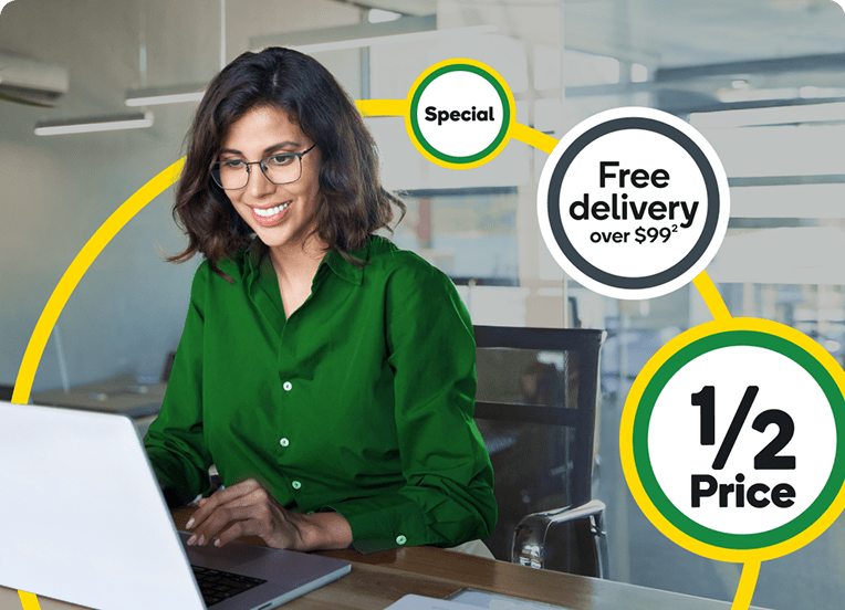 Lady in green shirt sitting at a desk working on a computer screen