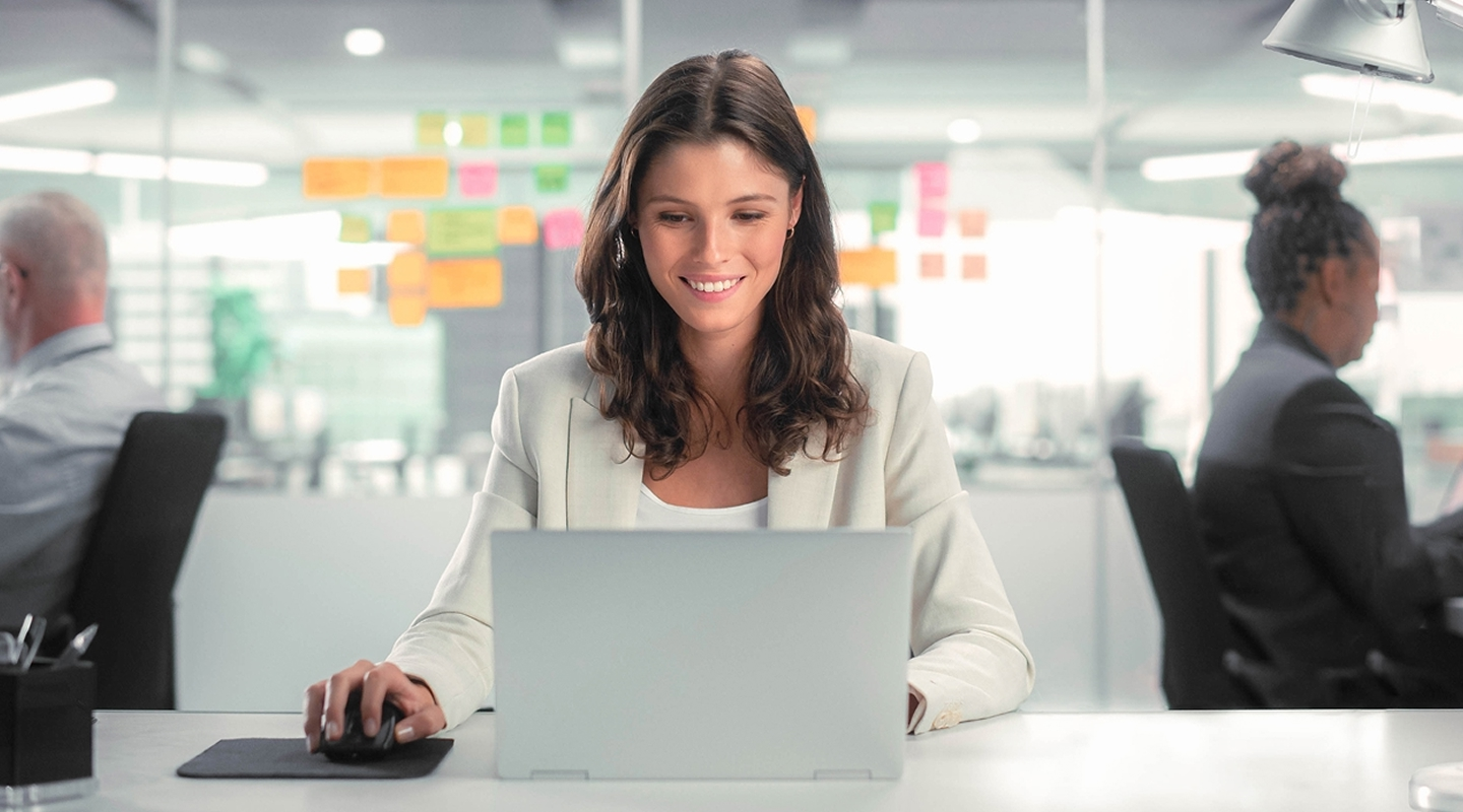 Business woman sitting in office at computer