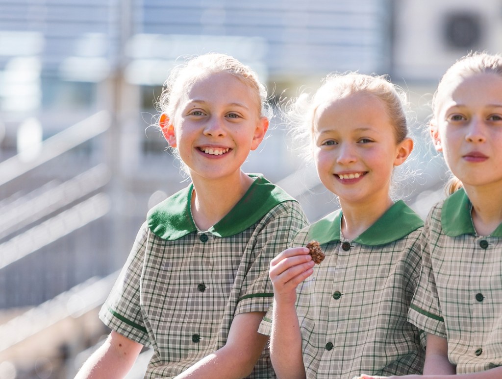 3 school girls eating a snack