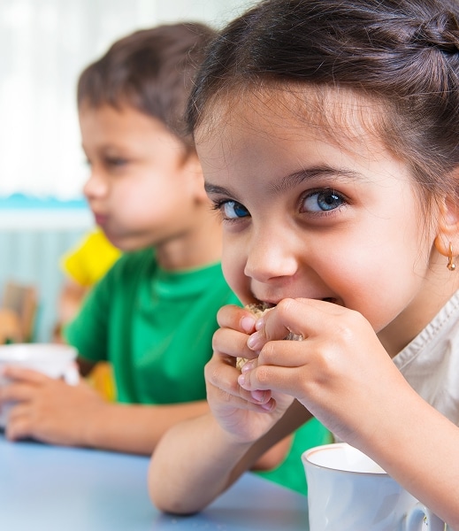 children eating lunch in daycare setting