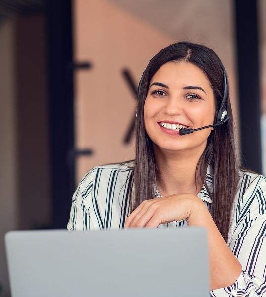 Customer service agent with headset and laptop
