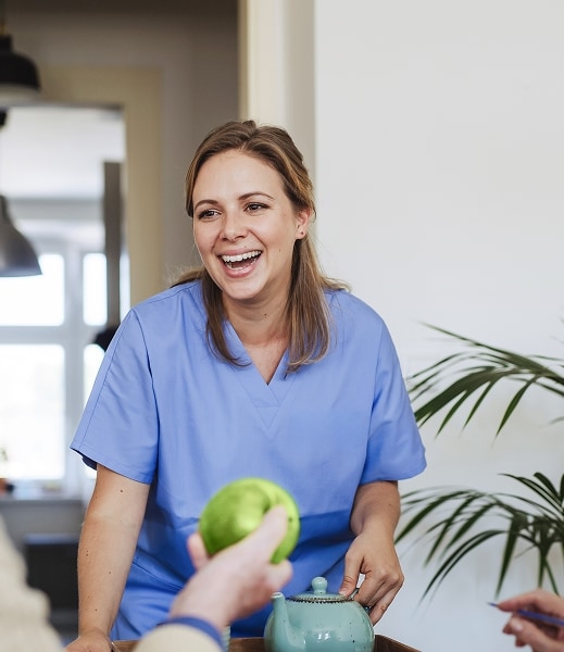 care worker having a tea with a resident